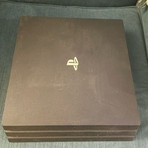 PlayStation 4 with 2 remote controllers and 3 games.